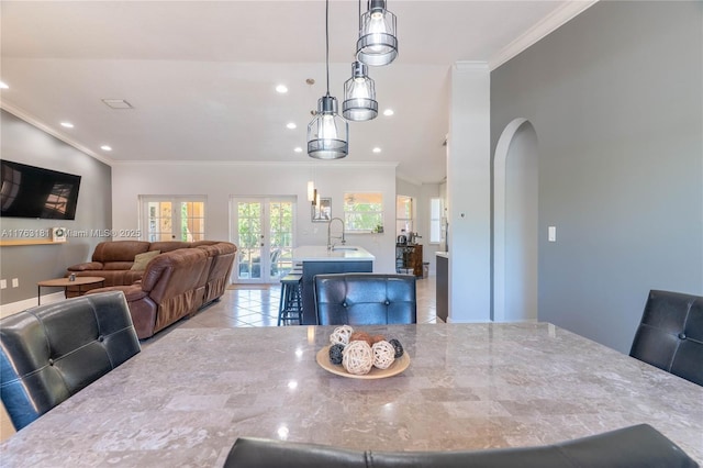 dining room with recessed lighting, french doors, arched walkways, and ornamental molding