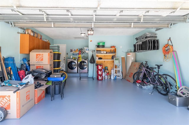 garage featuring washer and dryer and electric water heater