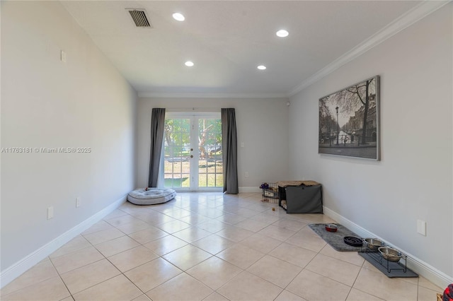 empty room featuring visible vents, ornamental molding, french doors, light tile patterned floors, and baseboards