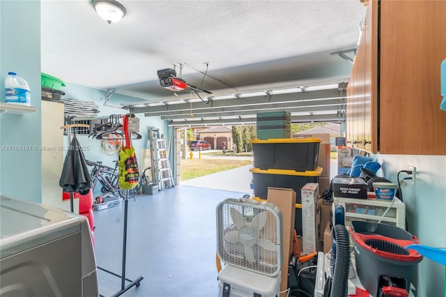 garage featuring washer / dryer and a garage door opener