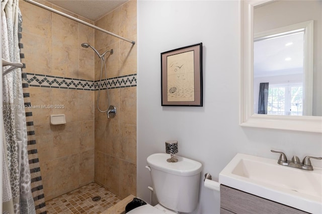 full bathroom featuring vanity, toilet, and a shower stall