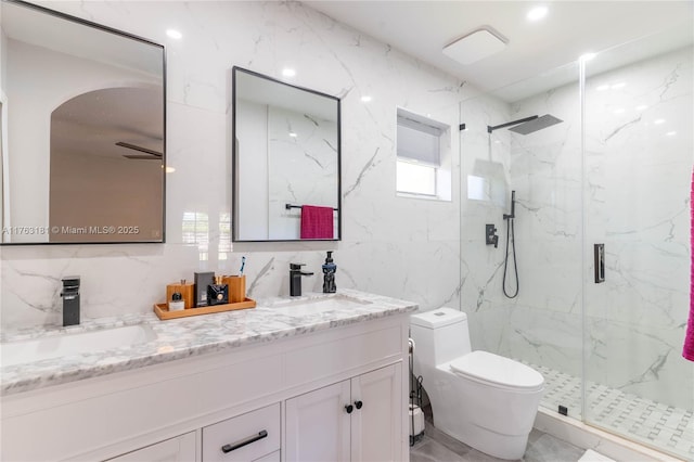 full bathroom with tile walls, toilet, a marble finish shower, and a sink