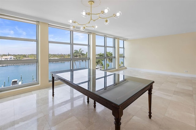 unfurnished dining area with a wall of windows, baseboards, a wealth of natural light, and a chandelier