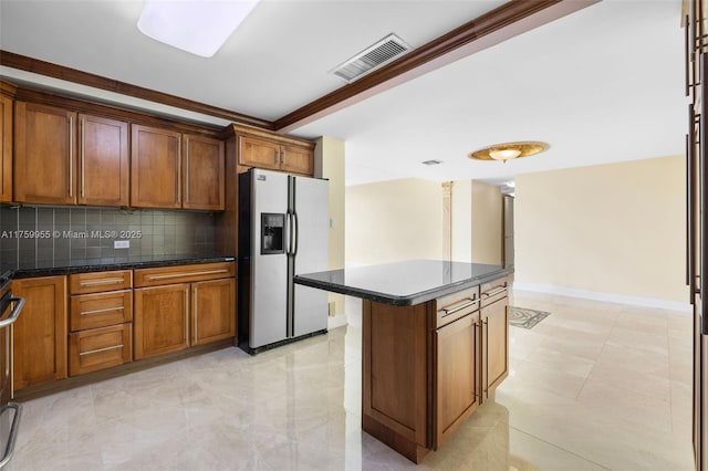 kitchen featuring tasteful backsplash, visible vents, brown cabinets, and stainless steel fridge with ice dispenser