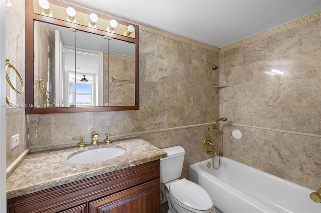 bathroom with backsplash, tile walls, toilet, bathing tub / shower combination, and vanity