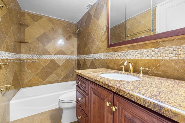 full bathroom with visible vents, toilet, shower / washtub combination, decorative backsplash, and vanity