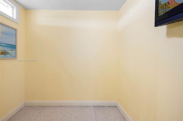 carpeted empty room with baseboards