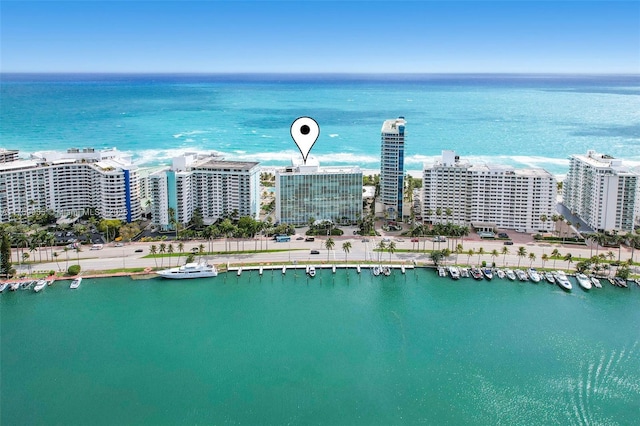 birds eye view of property featuring a view of city and a water view