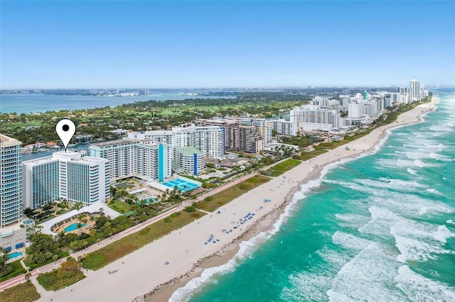 aerial view with a water view, a city view, and a beach view