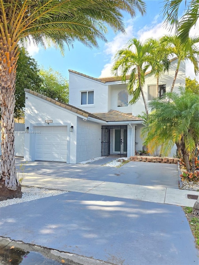 view of front of house featuring concrete driveway and an attached garage