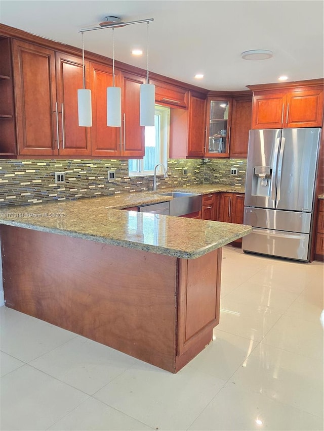 kitchen with light stone countertops, light tile patterned flooring, stainless steel fridge with ice dispenser, decorative backsplash, and glass insert cabinets