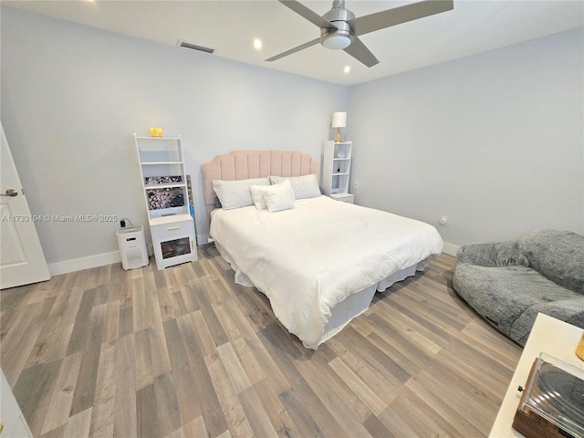 bedroom featuring recessed lighting, wood finished floors, visible vents, and baseboards