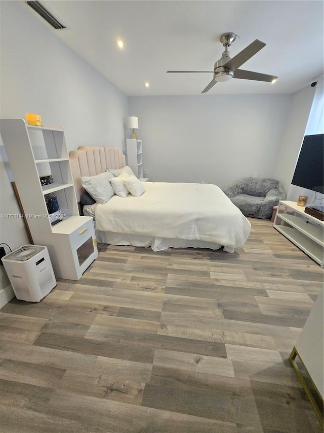 bedroom featuring visible vents, recessed lighting, ceiling fan, and wood finished floors