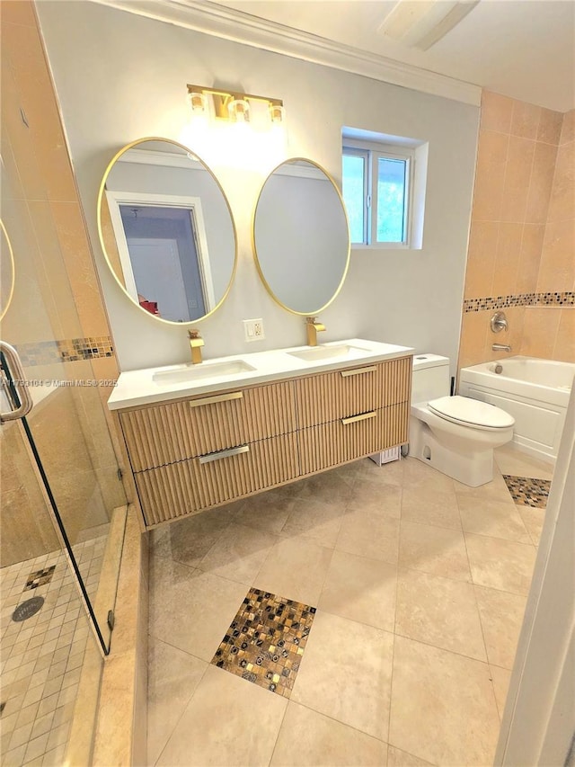 bathroom featuring tile patterned flooring, ornamental molding, a tile shower, and a sink