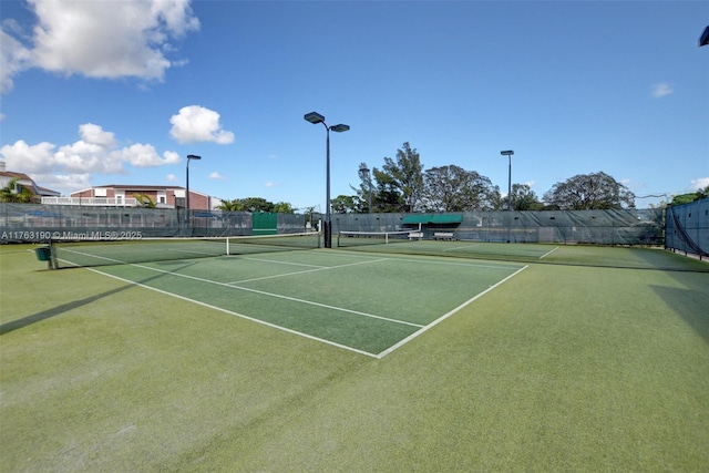 view of tennis court featuring fence