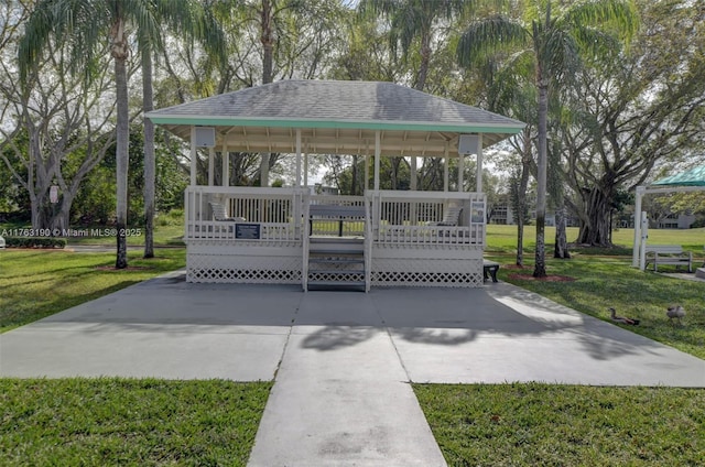 view of community featuring a deck, a gazebo, and a lawn