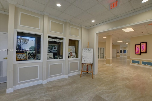 unfurnished room with recessed lighting, a paneled ceiling, and a decorative wall