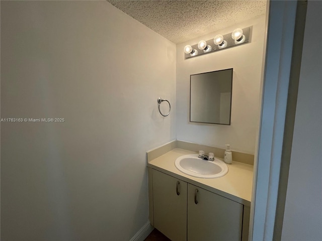 bathroom with a textured ceiling and vanity