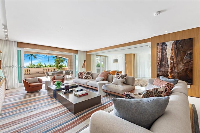 carpeted living area with wooden walls