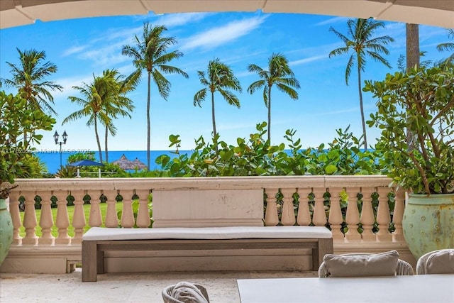 view of patio with a balcony and a water view