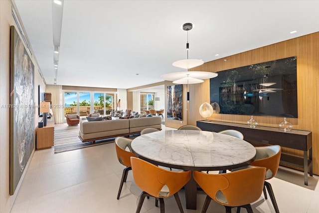 dining area featuring wood walls