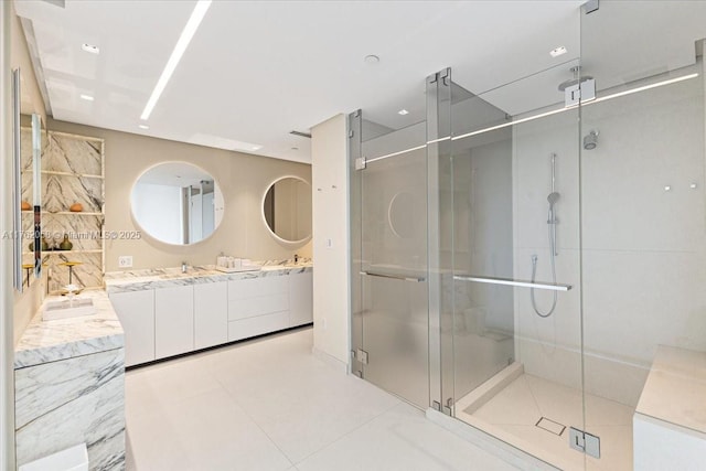 full bathroom featuring tile patterned floors, a stall shower, and vanity