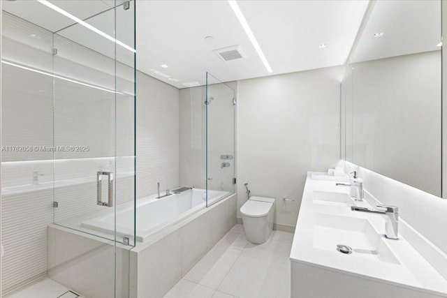 bathroom featuring tile patterned floors, toilet, and a sink