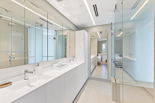 full bathroom with visible vents, double vanity, a sink, tile patterned floors, and connected bathroom