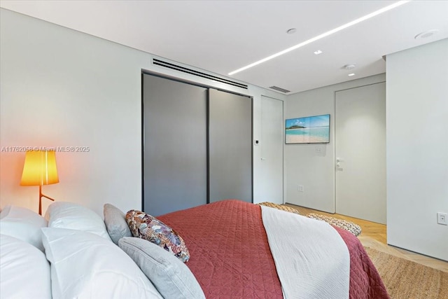 bedroom with visible vents and a closet