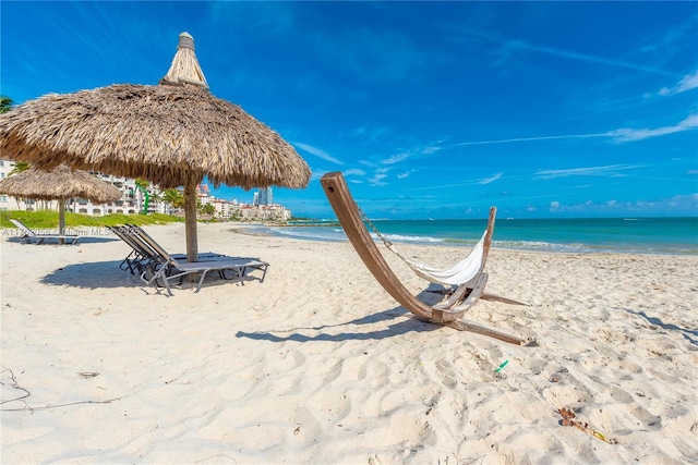 water view with a gazebo and a beach view