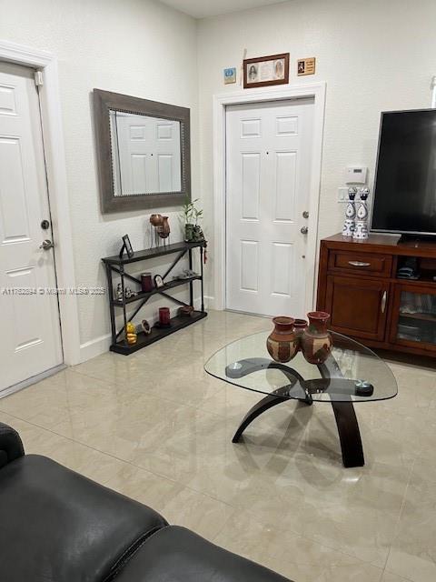 tiled foyer entrance featuring baseboards