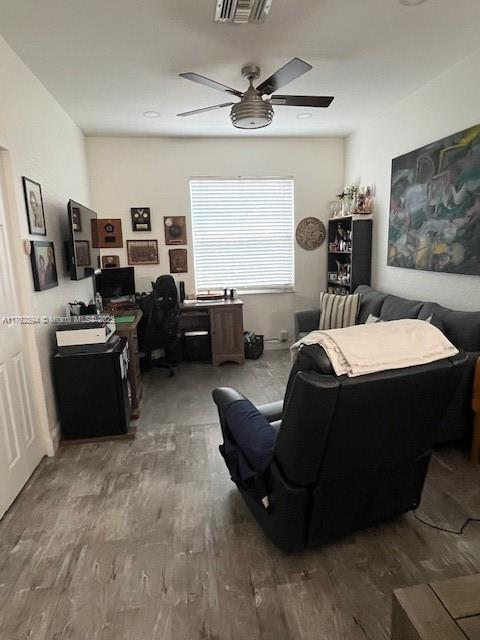 office area featuring ceiling fan, visible vents, and wood finished floors