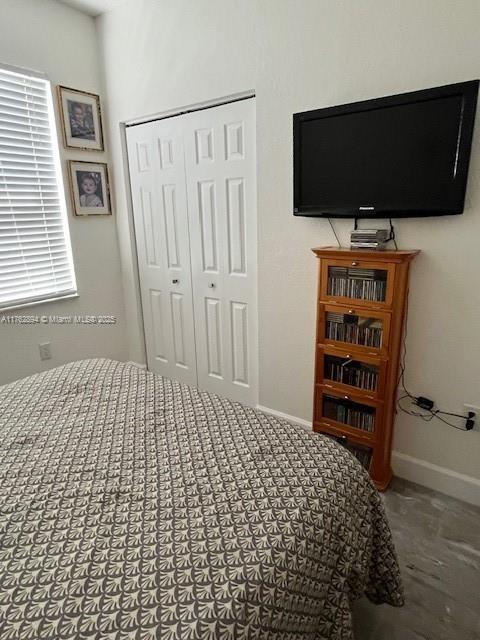 bedroom featuring a closet and baseboards