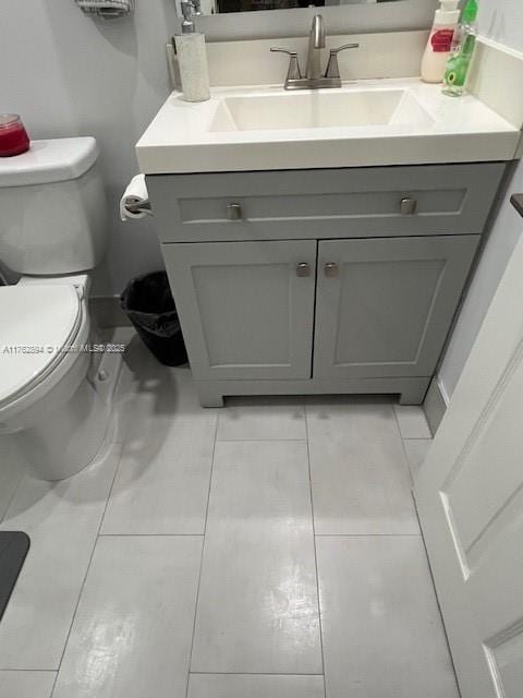 half bath featuring toilet and vanity