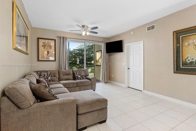 living room featuring light tile patterned flooring, baseboards, visible vents, and ceiling fan