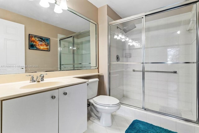 full bathroom with vanity, a shower stall, toilet, and tile patterned floors