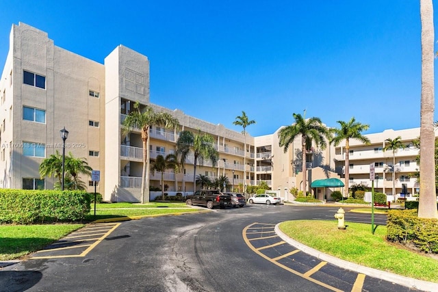 view of building exterior with uncovered parking