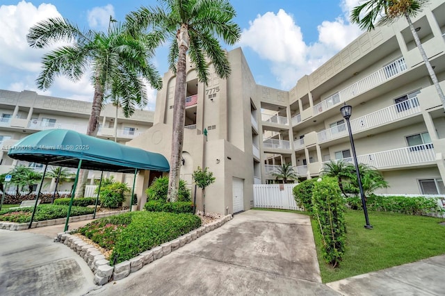 view of property featuring concrete driveway