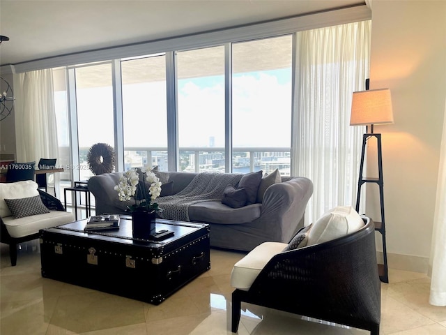 living area with light tile patterned floors, a healthy amount of sunlight, baseboards, and expansive windows