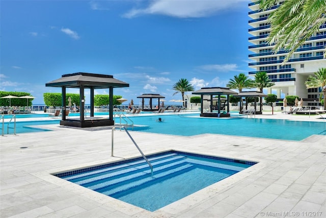 pool featuring a gazebo and a patio area