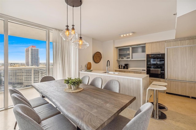 dining room featuring a wall of windows and a city view