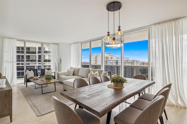 dining space with expansive windows, a city view, light tile patterned flooring, and a healthy amount of sunlight