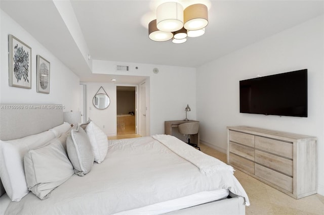 bedroom featuring a notable chandelier, baseboards, visible vents, and ensuite bathroom