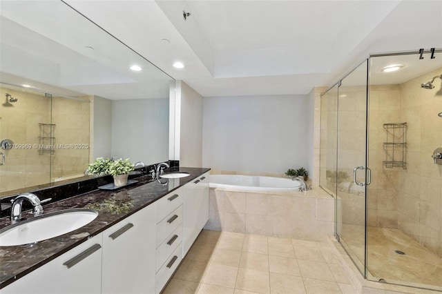 bathroom featuring a shower stall, a garden tub, tile patterned floors, and a sink