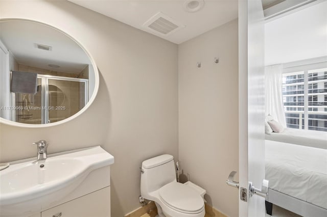 bathroom featuring visible vents, vanity, toilet, and a shower stall