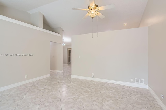 spare room with vaulted ceiling, a ceiling fan, baseboards, and visible vents