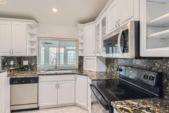 kitchen with a sink, white cabinets, appliances with stainless steel finishes, and open shelves