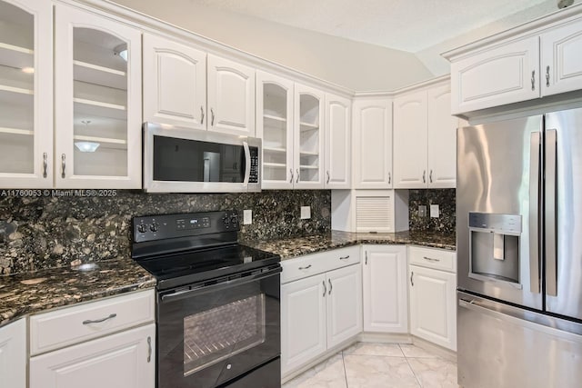 kitchen featuring tasteful backsplash, dark stone counters, appliances with stainless steel finishes, marble finish floor, and white cabinetry