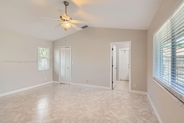 spare room with visible vents, baseboards, ceiling fan, and vaulted ceiling