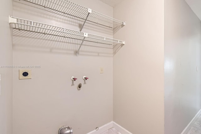 laundry room with electric dryer hookup, baseboards, gas dryer hookup, and washer hookup